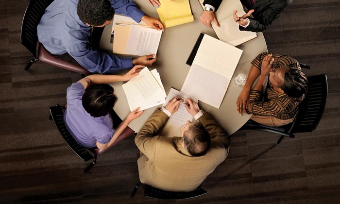 Circle of Professionals Around a Table